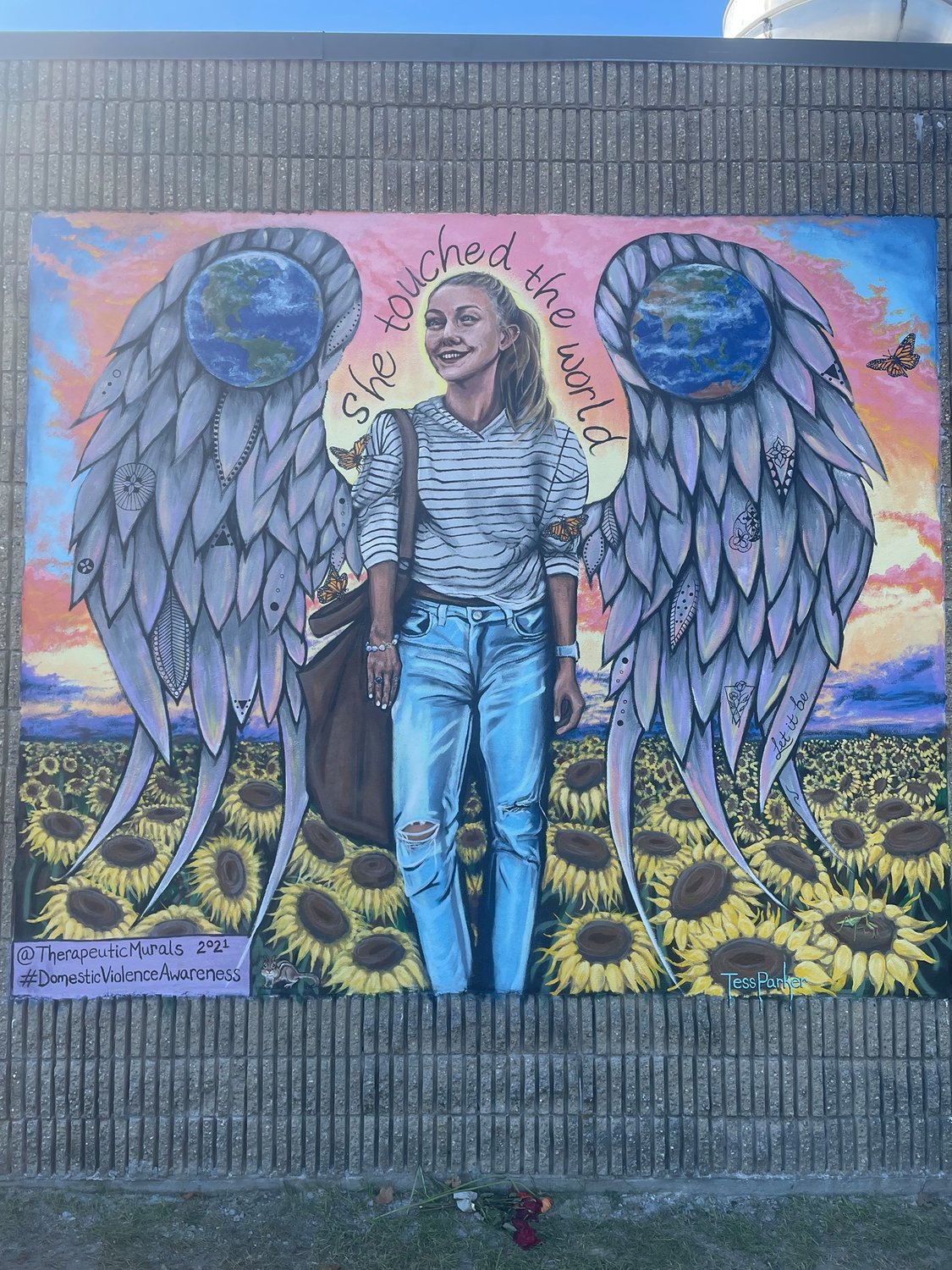 The Gabby Petito mural by Tess Parker of Therapeutic Murals is located just east of Nicolls Road on the east-facing wall of the building in the Mazzei & Blair Plaza in Blue Point.